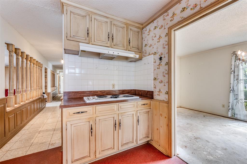 5001 Boulder Lake Road Fort Worth, TX 76103 - Photo 5 of 22 a kitchen with white cabinets and a stove
