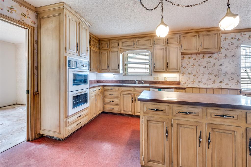 5001 Boulder Lake Road Fort Worth, TX 76103 - Photo 6 of 22 a kitchen with white cabinets and sink