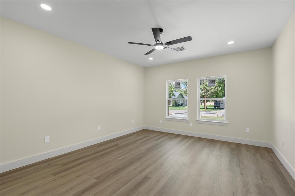 3320 North 27th Street Waco, TX 76708 - Photo 19 of 38 an empty room with wooden floor fan and windows