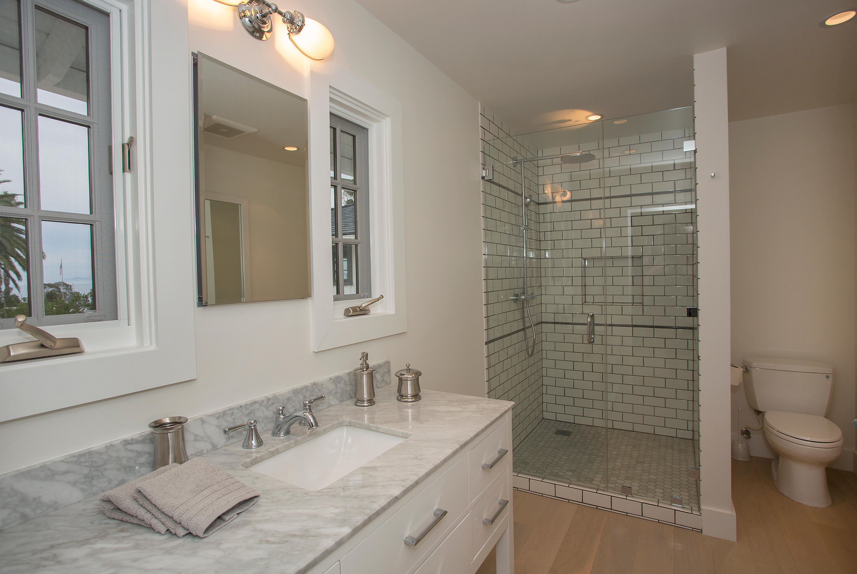527 Meigs Road Santa Barbara, CA 93109 - Photo 13 of 30 a bathroom with a granite countertop sink a toilet and shower