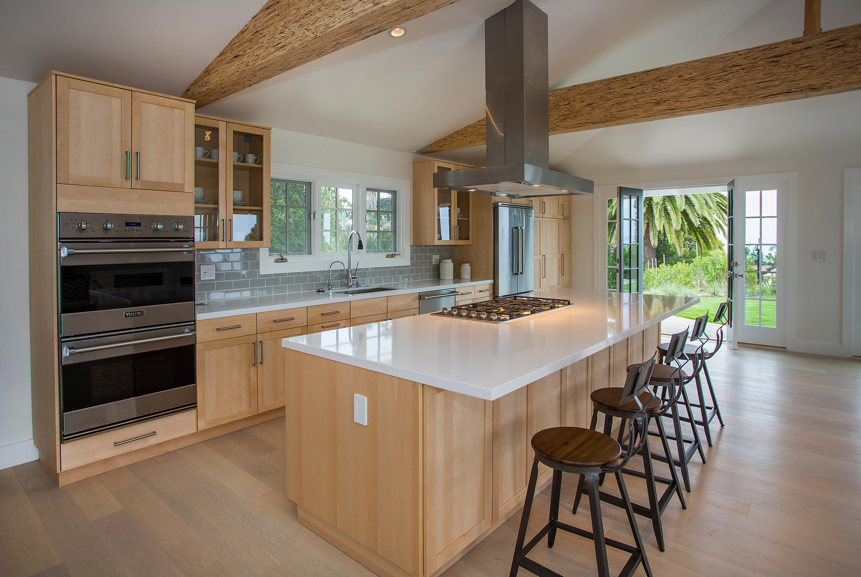 527 Meigs Road Santa Barbara, CA 93109 - Photo 3 of 30 a kitchen with stainless steel appliances kitchen island granite countertop a stove a refrigerator a kitchen island with a stove and white cabinets