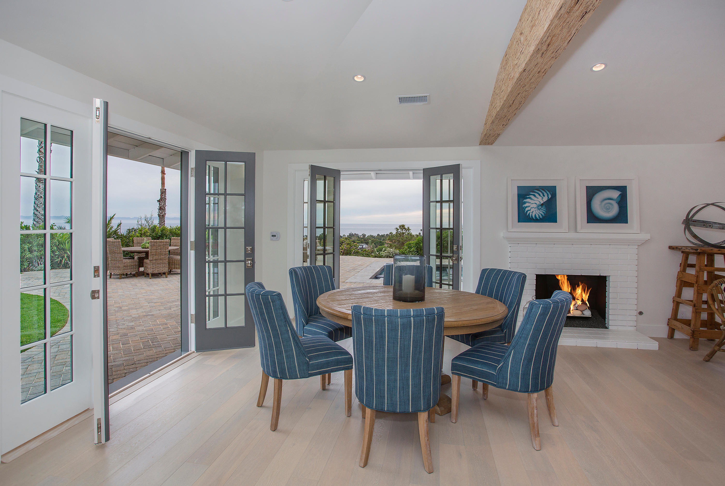 527 Meigs Road Santa Barbara, CA 93109 - Photo 4 of 30 a dining room with furniture a fireplace and wooden floor