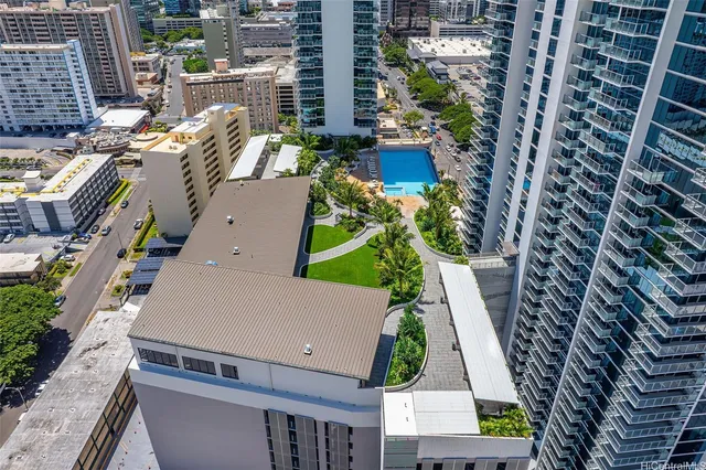 a gym room with lots of gym equipment and a view of living room