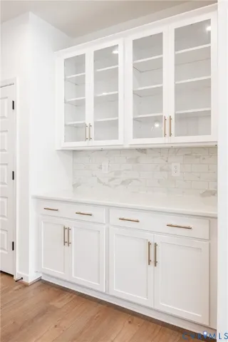a view of white cabinets with a wooden floors