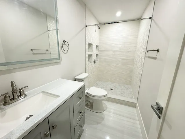 a bathroom with a sink toilet and shower