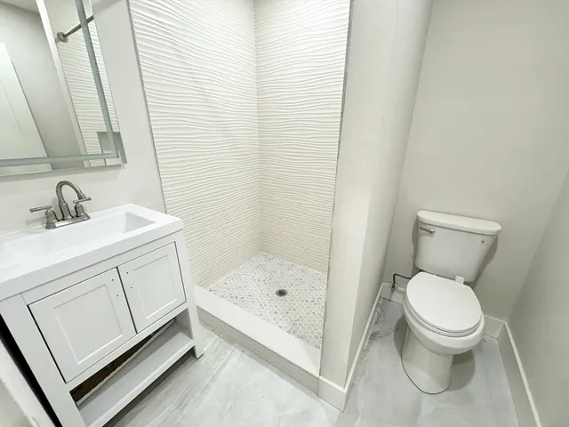a bathroom with a sink toilet and shower