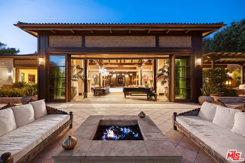 a living room with furniture a flat screen tv and gym equipment