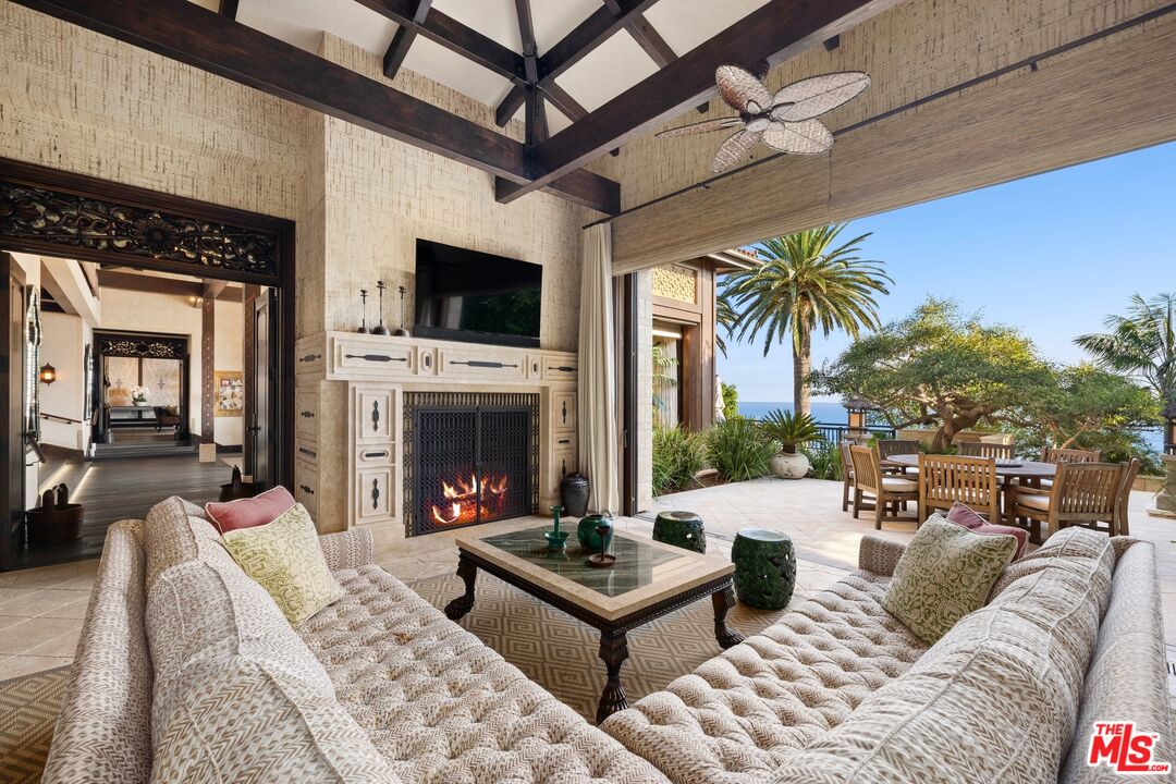 24834 Pacific Coast Highway Malibu, CA 90265 - Photo 17 of 50 a living room with furniture fireplace and a flat screen tv