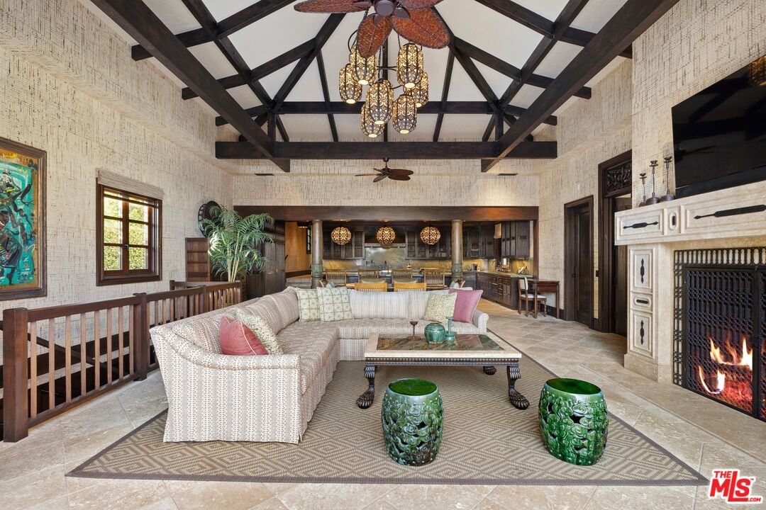 24834 Pacific Coast Highway Malibu, CA 90265 - Photo 18 of 50 a living room with fireplace furniture and a flat screen tv