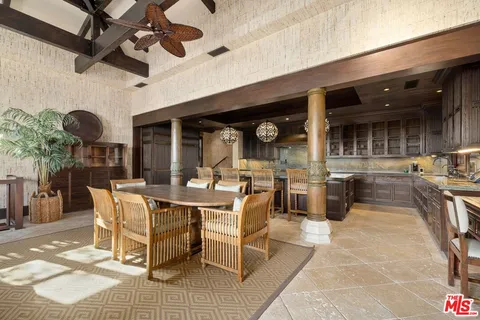 a view of a patio with table and chairs potted plants with wooden floor