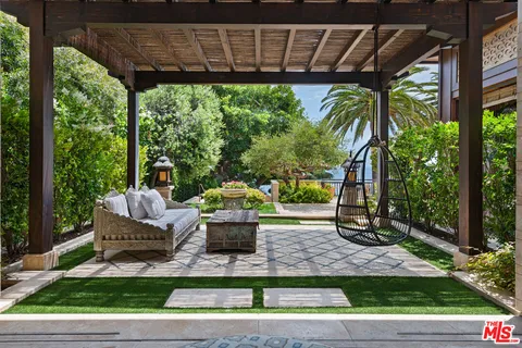 a spacious bedroom with a bed a table and chair