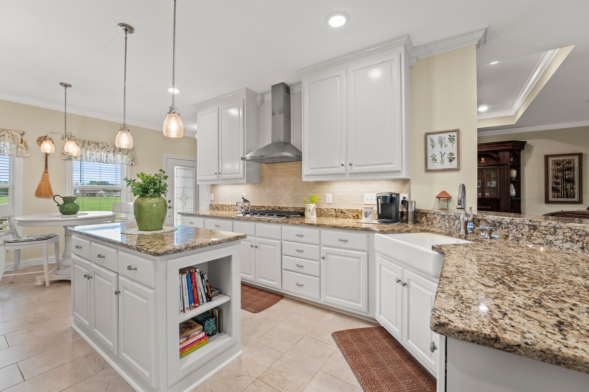 285 Hancock Lane Tullahoma, TN 37388 - Photo 16 of 79 a kitchen with stainless steel appliances kitchen island granite countertop a stove a sink dishwasher and white cabinets with wooden floor