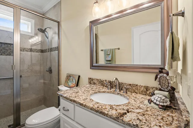 a living room with furniture kitchen view and a flat screen tv