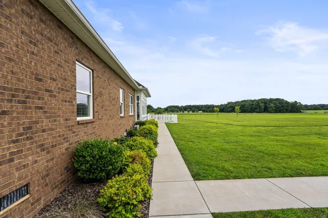 a view of a house with a yard and a garden