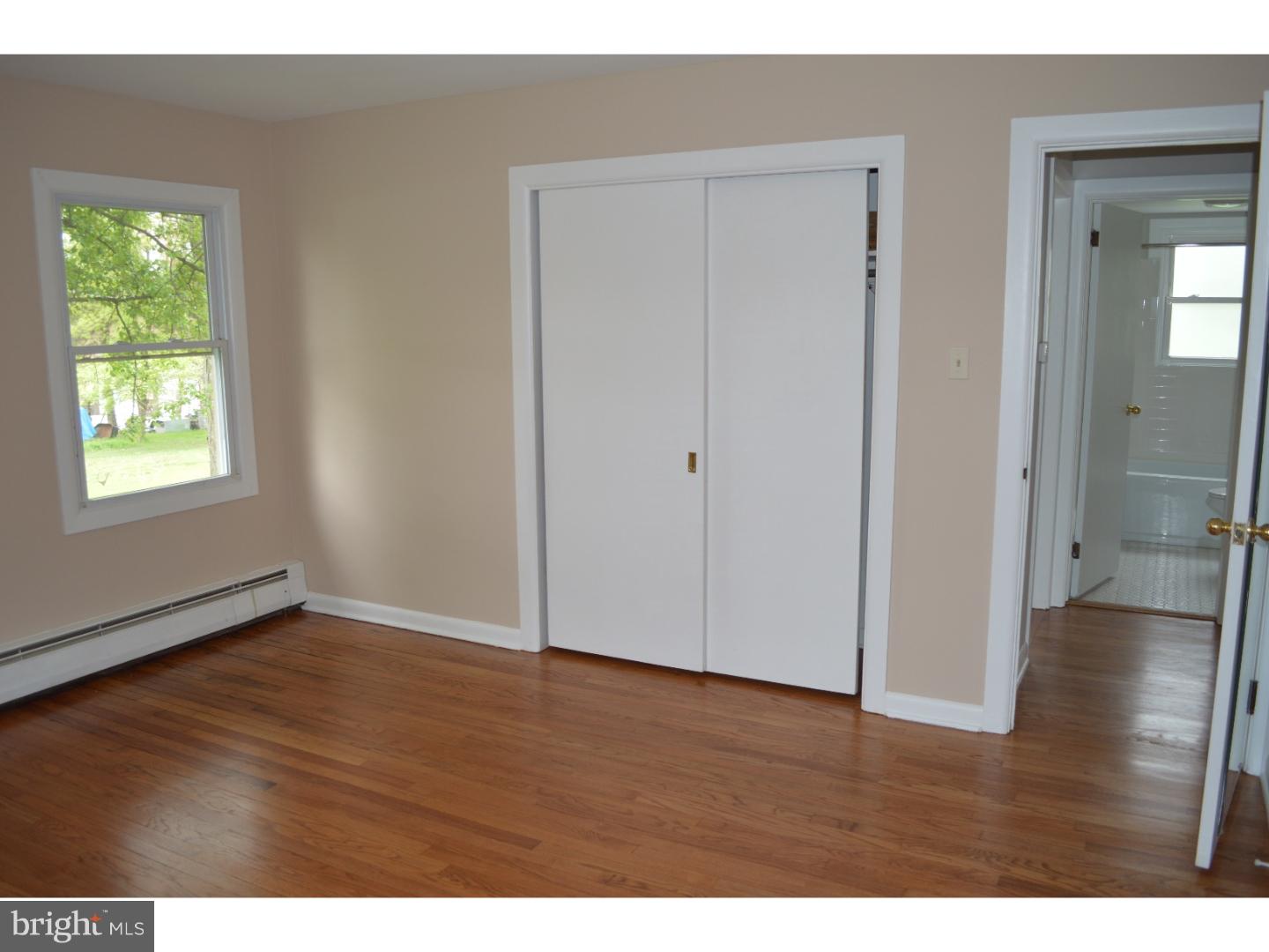 1112 Callowhill Road Perkasie, PA 18944 - Photo 11 of 17 a view of an empty room with wooden floor and a window
