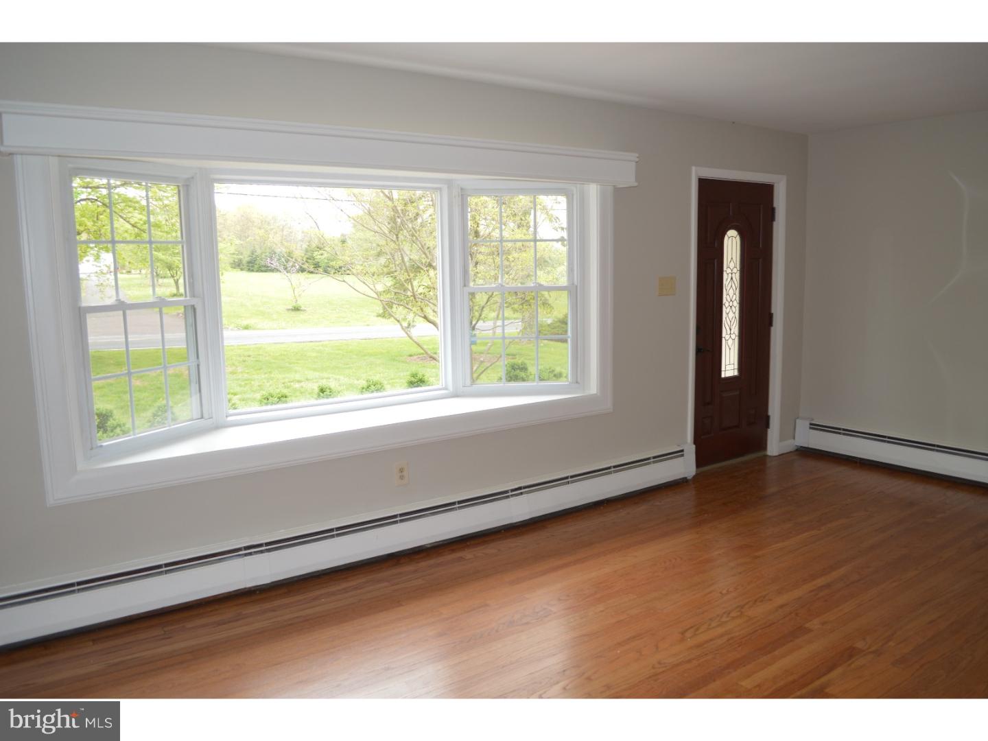 1112 Callowhill Road Perkasie, PA 18944 - Photo 4 of 17 a view of an empty room with wooden floor and a window