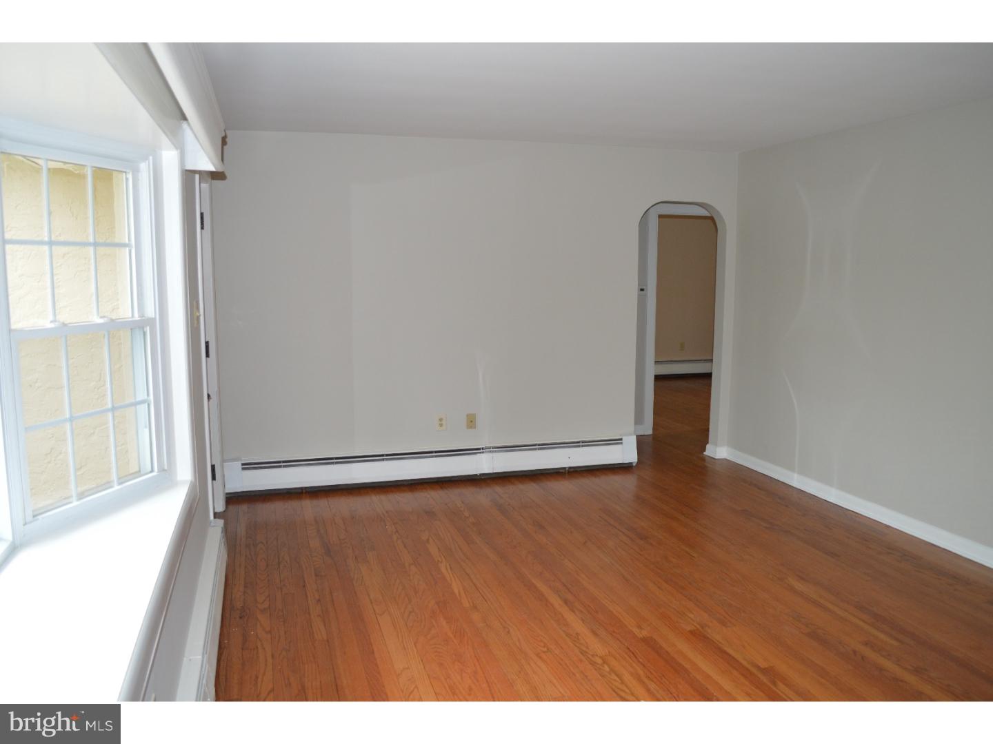 1112 Callowhill Road Perkasie, PA 18944 - Photo 5 of 17 a view of an empty room with wooden floor and a window