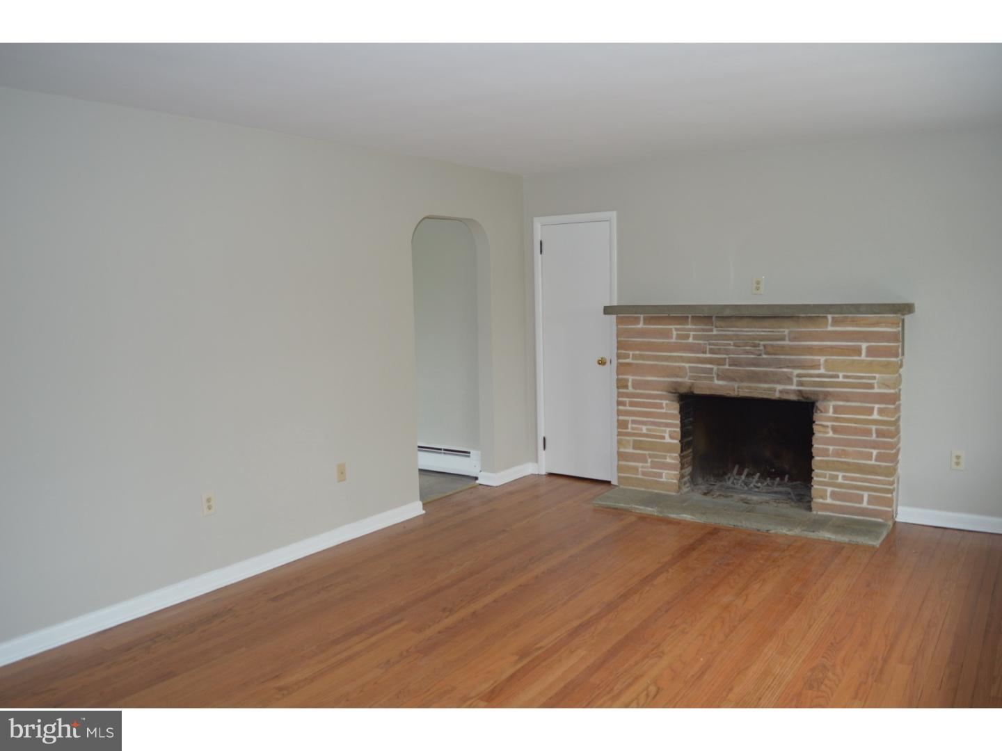 1112 Callowhill Road Perkasie, PA 18944 - Photo 7 of 17 a view of empty room with wooden floor and fireplace