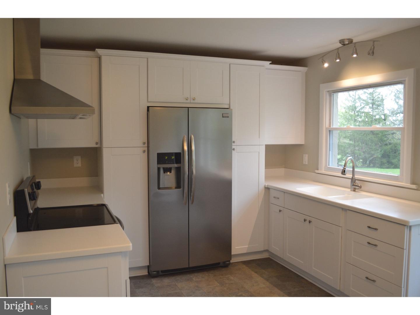 1112 Callowhill Road Perkasie, PA 18944 - Photo 9 of 17 a kitchen with a refrigerator sink and cabinets