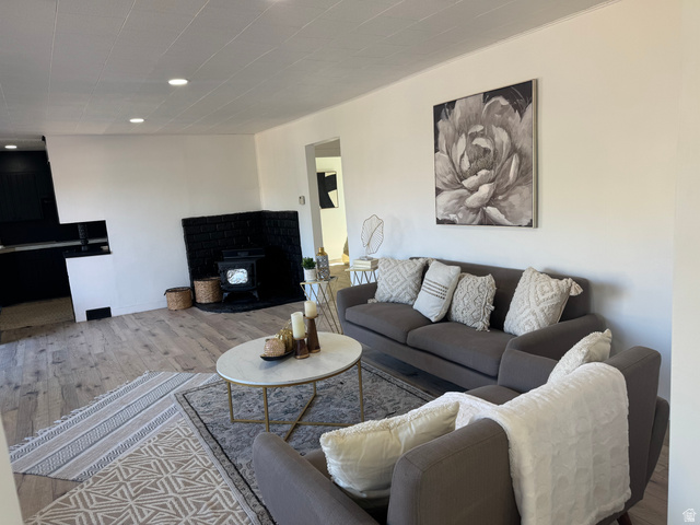 47 B Street Helper, UT 84526 - Photo 3 of 19 Expansive living area with wood-finish flooring, a black brick fireplace, and recessed lighting