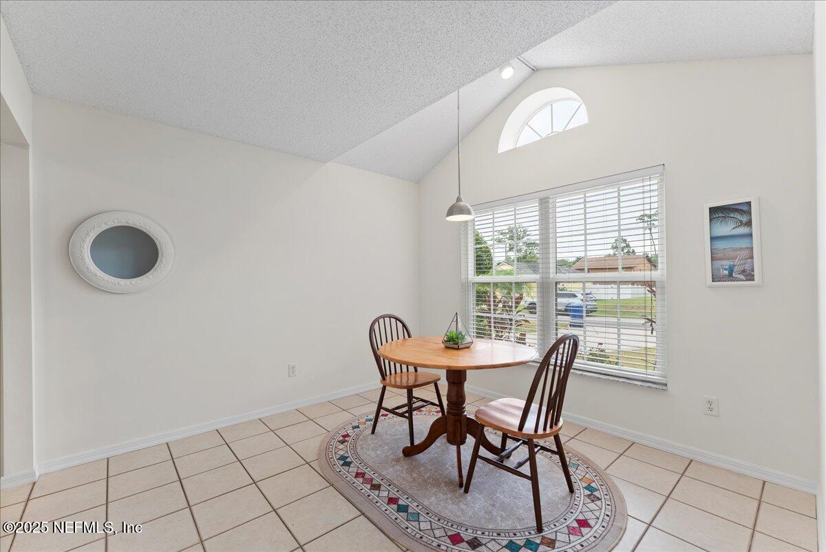 210 Dartmouth Road St. Augustine, FL 32086 - Photo 15 of 27 a view of a dining room with furniture and a window