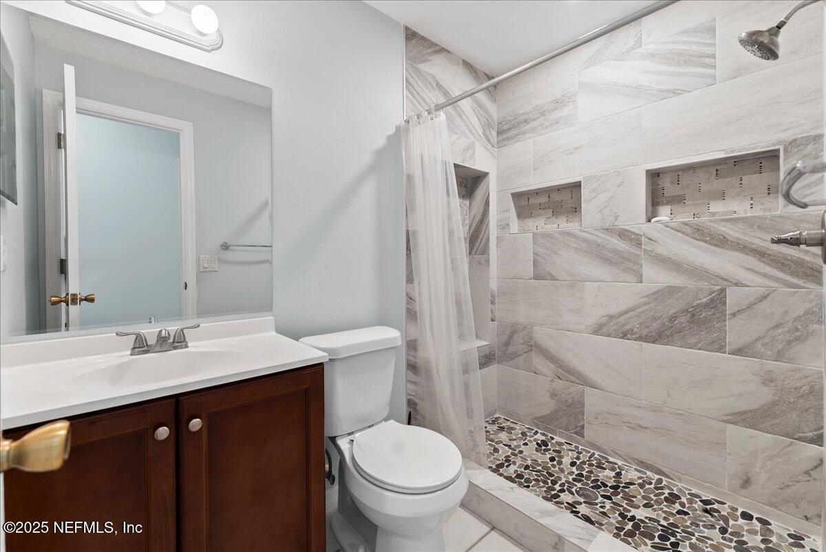 210 Dartmouth Road St. Augustine, FL 32086 - Photo 16 of 27 a bathroom with a double vanity sink toilet and shower