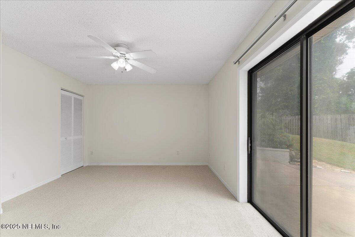 210 Dartmouth Road St. Augustine, FL 32086 - Photo 20 of 27 an empty room with a ceiling fan and a window