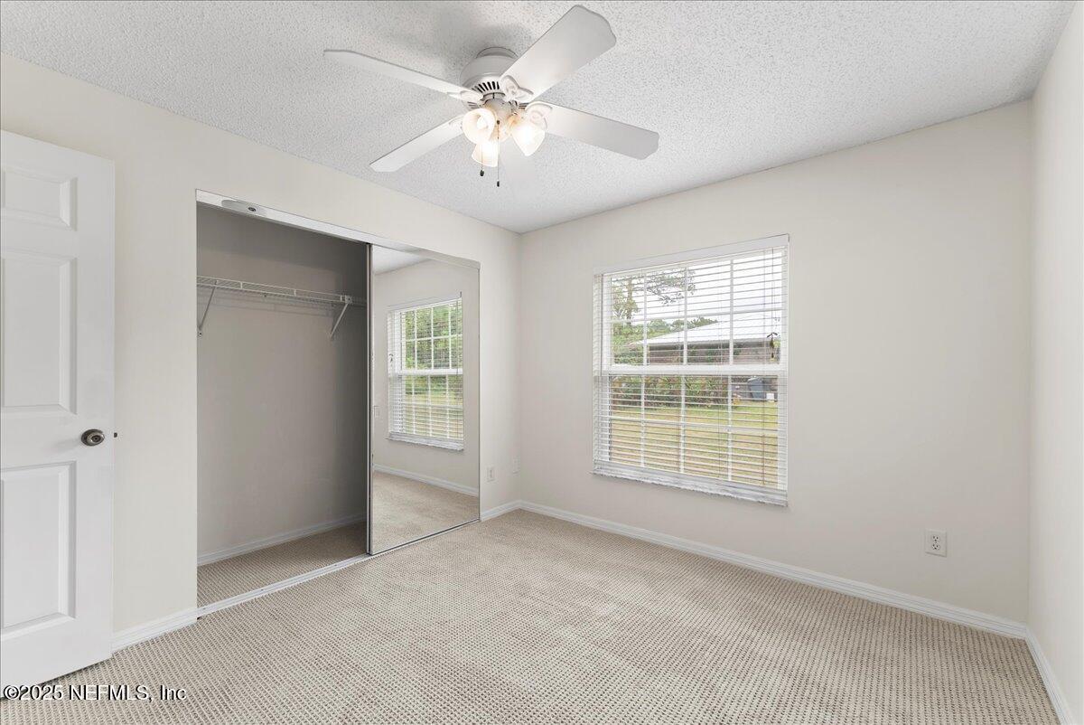 210 Dartmouth Road St. Augustine, FL 32086 - Photo 25 of 27 an empty room with windows and fan