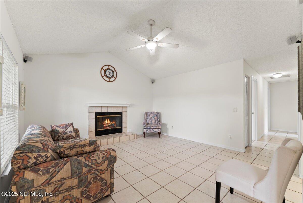 210 Dartmouth Road St. Augustine, FL 32086 - Photo 9 of 27 a bedroom with furniture and a fireplace