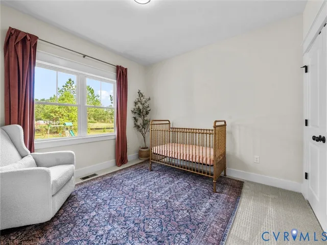 a view of a bedroom with furniture and a window