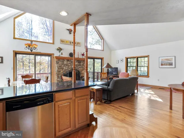 a kitchen with stainless steel appliances granite countertop a refrigerator a stove top oven a sink and dishwasher