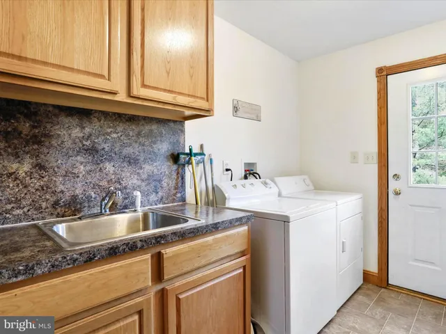 a bedroom with a bed a couch and a window