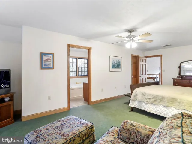 a bedroom with a large bed and a couch