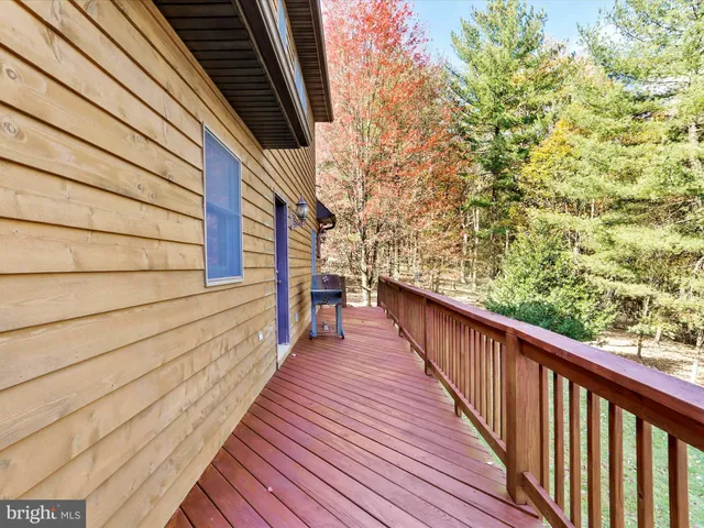 a view of balcony with wooden floor and seating space