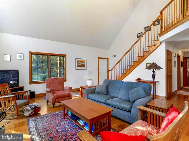 a living room with furniture a rug and a chandelier