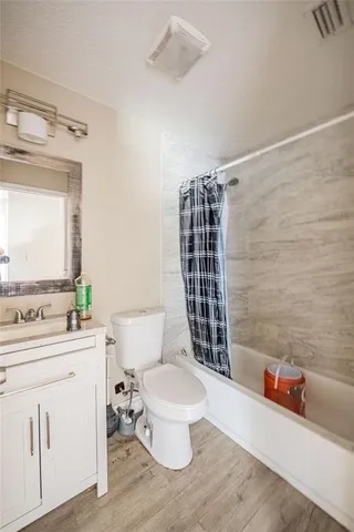 a bathroom with a toilet a sink and a shower