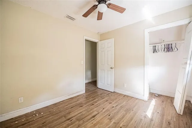 a view of an empty room with wooden floor