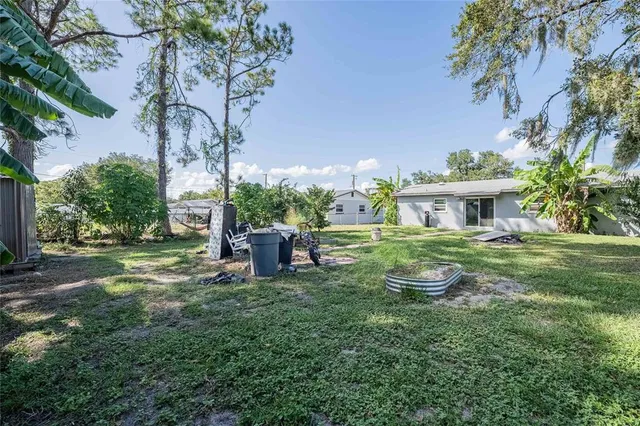a view of a house with backyard porch and sitting area
