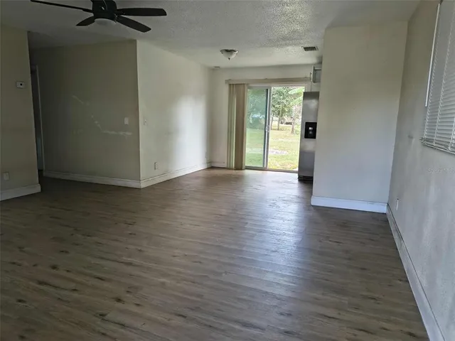a view of a room with wooden floor and a window