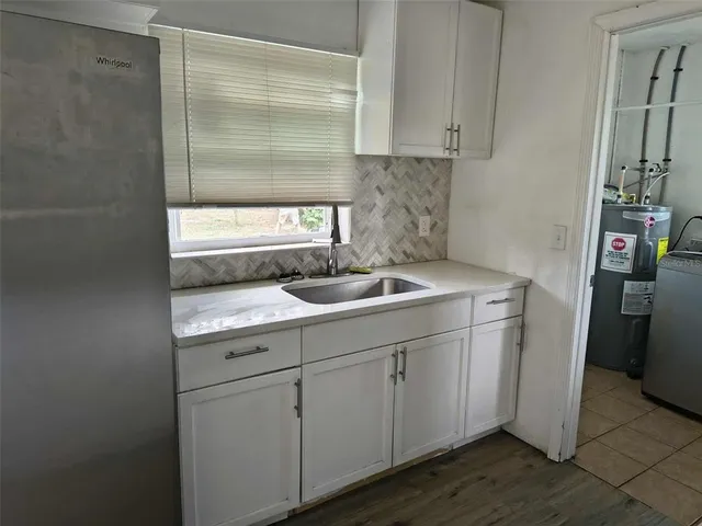 a kitchen with a sink and cabinets