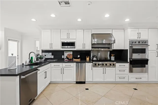a kitchen with a stove and white cabinets