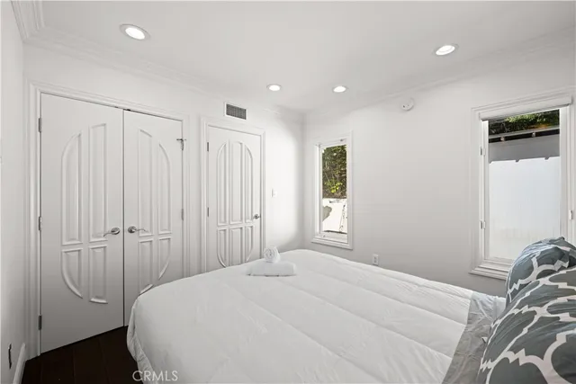 a spacious bedroom with a bed and a walk in closet
