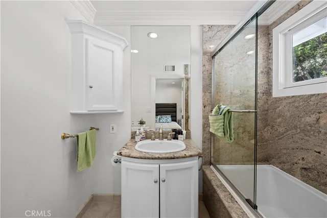 a bedroom with a bed and a view of bathroom