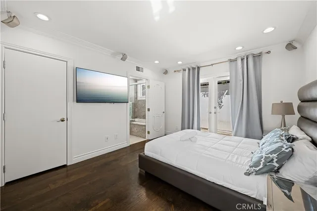 a bathroom with a granite countertop sink and mirror with bathtub
