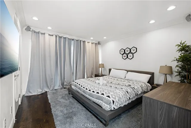 a bedroom with furniture and a flat screen tv