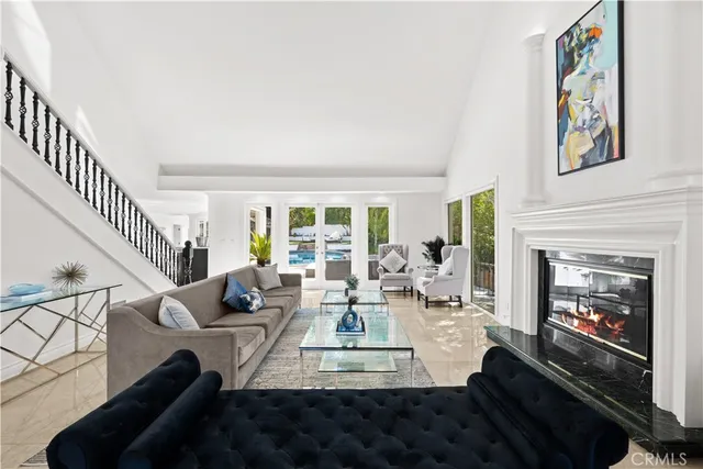 a living room with furniture fireplace and a window
