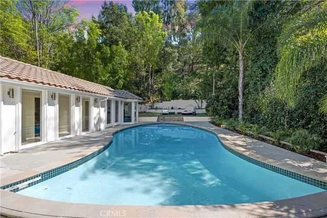 a view of swimming pool with seating space