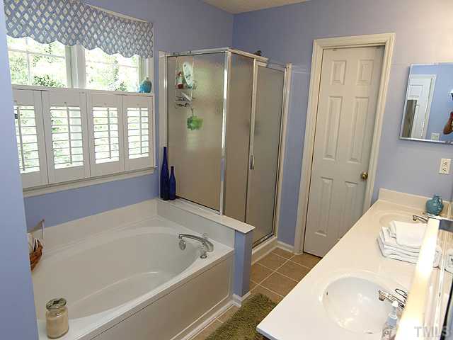 5404 Stewartby Drive Raleigh, NC 27613 - Photo 8 of 12 New Tile Flooring, Dual Vanity, Separate Shower, Garden Tub, Plantation Shutters, and Large Walk-In Closet. Get ready each morning in this spacious master bath!