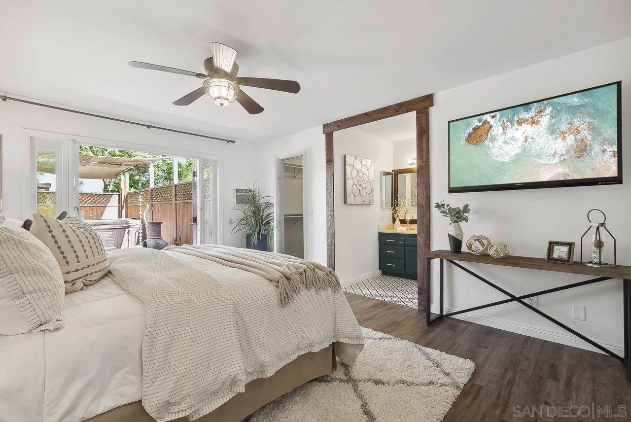 1369 Friends Way Fallbrook, CA 92028 - Photo 13 of 29 a bedroom with a bed and glass walk in closet