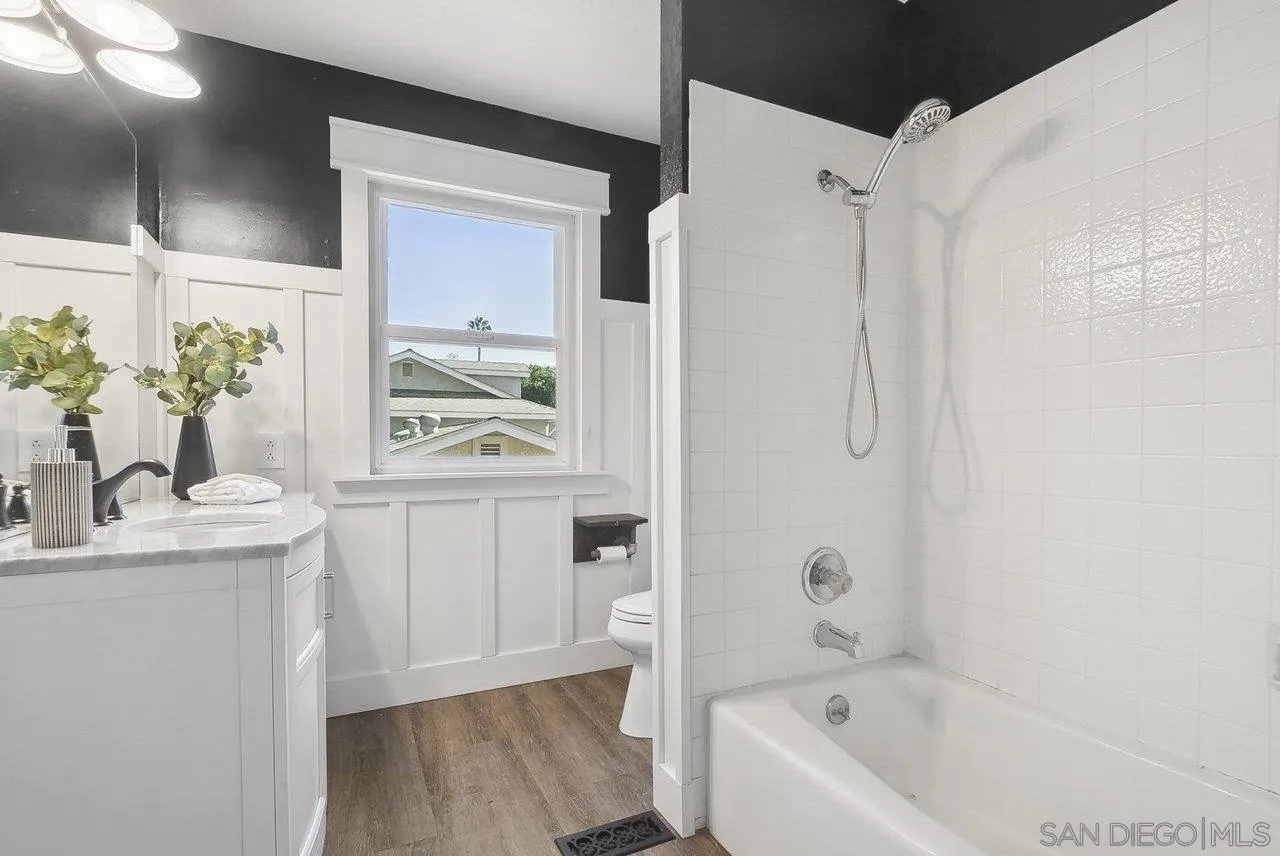 1369 Friends Way Fallbrook, CA 92028 - Photo 17 of 29 a bathroom with a granite countertop sink a bathtub and shower
